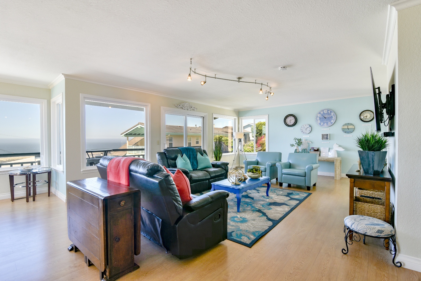 The living room features comfortable seating, a flat screen tv, and views from every angle