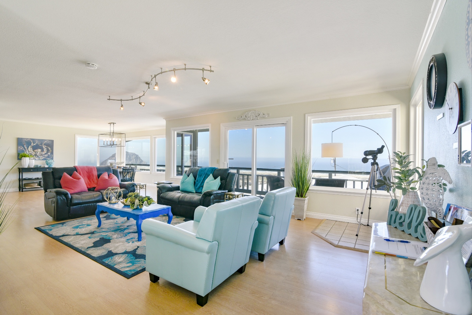 Living room with cozy furniture and doors to main floor balcony patio and bbq