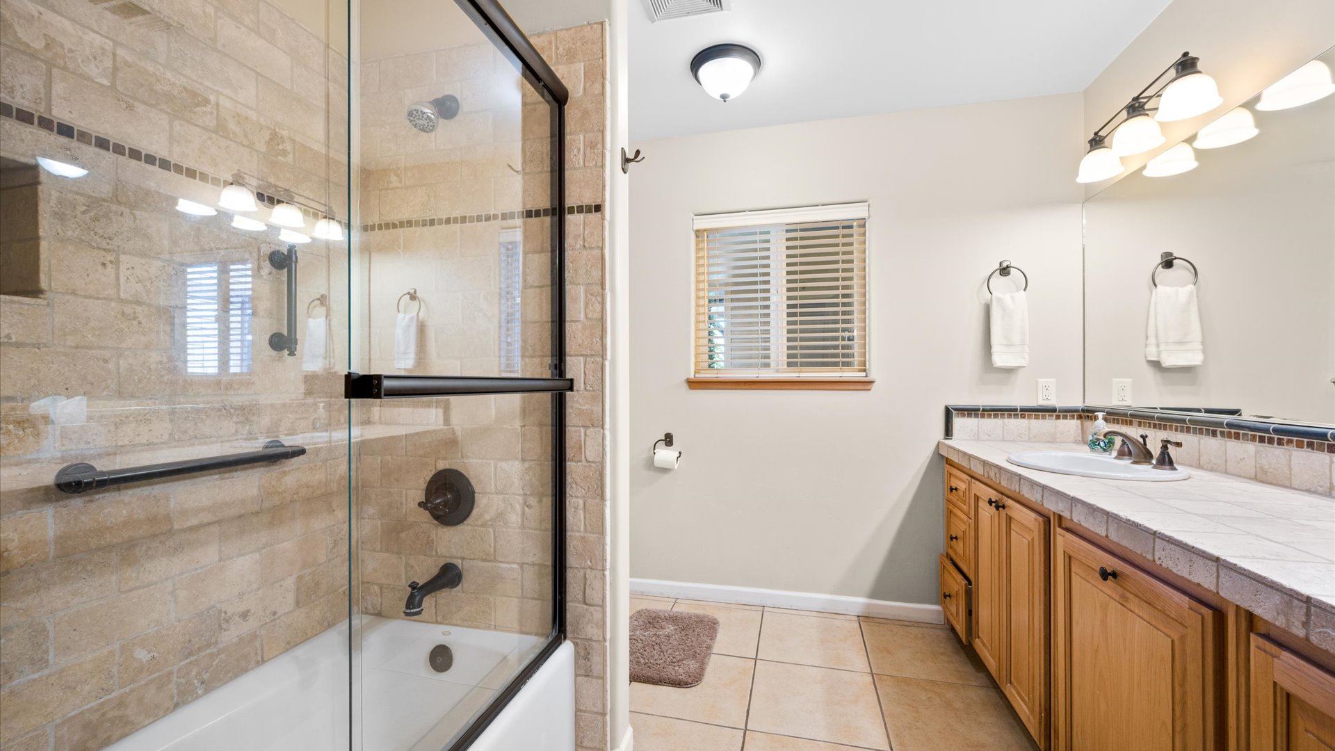 Downstairs bathroom shared by the second and third bedrooms features a shower/tub combination