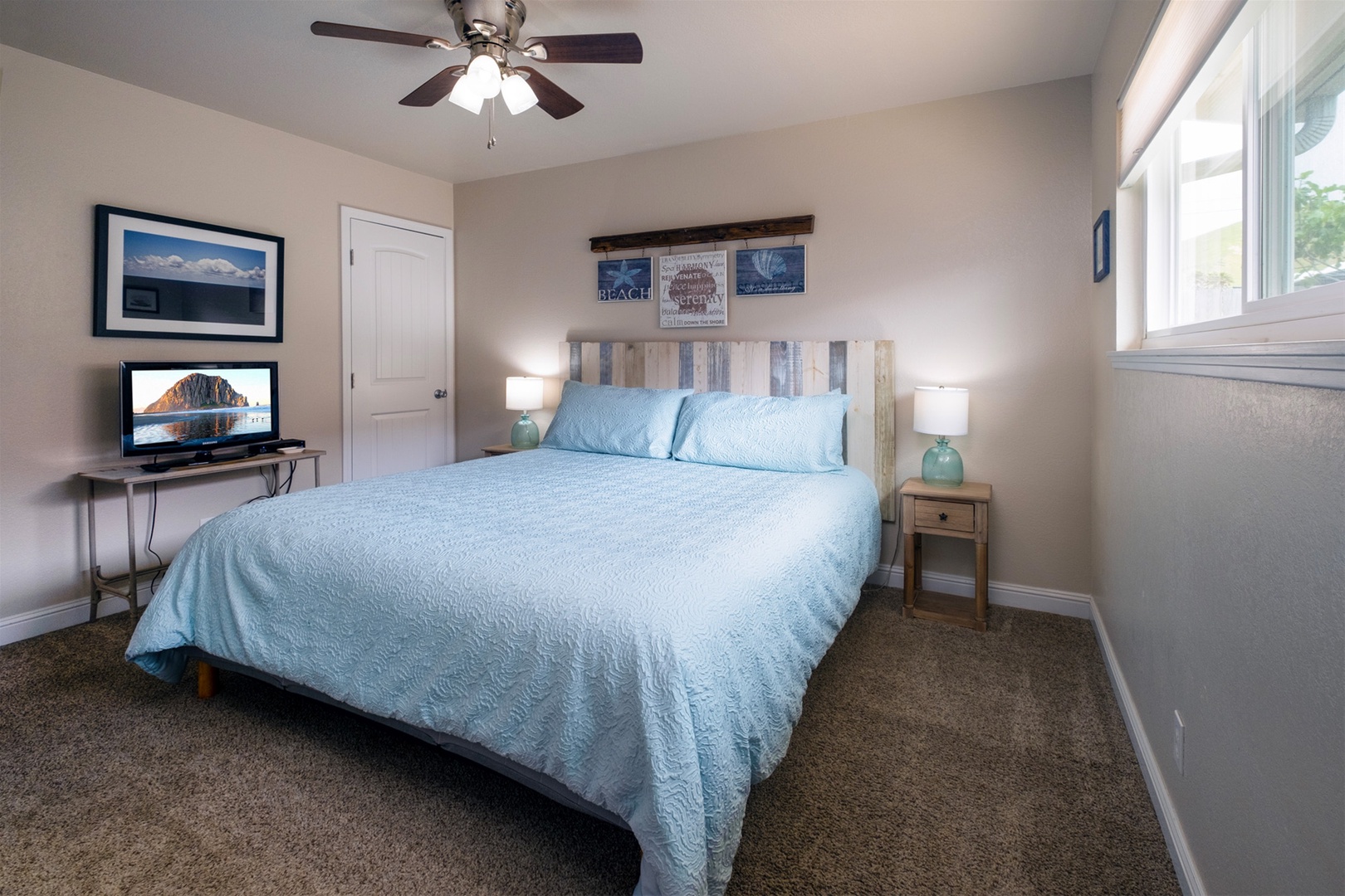 Tastefully decorated master bedroom with queen bed and ensuite bathroom