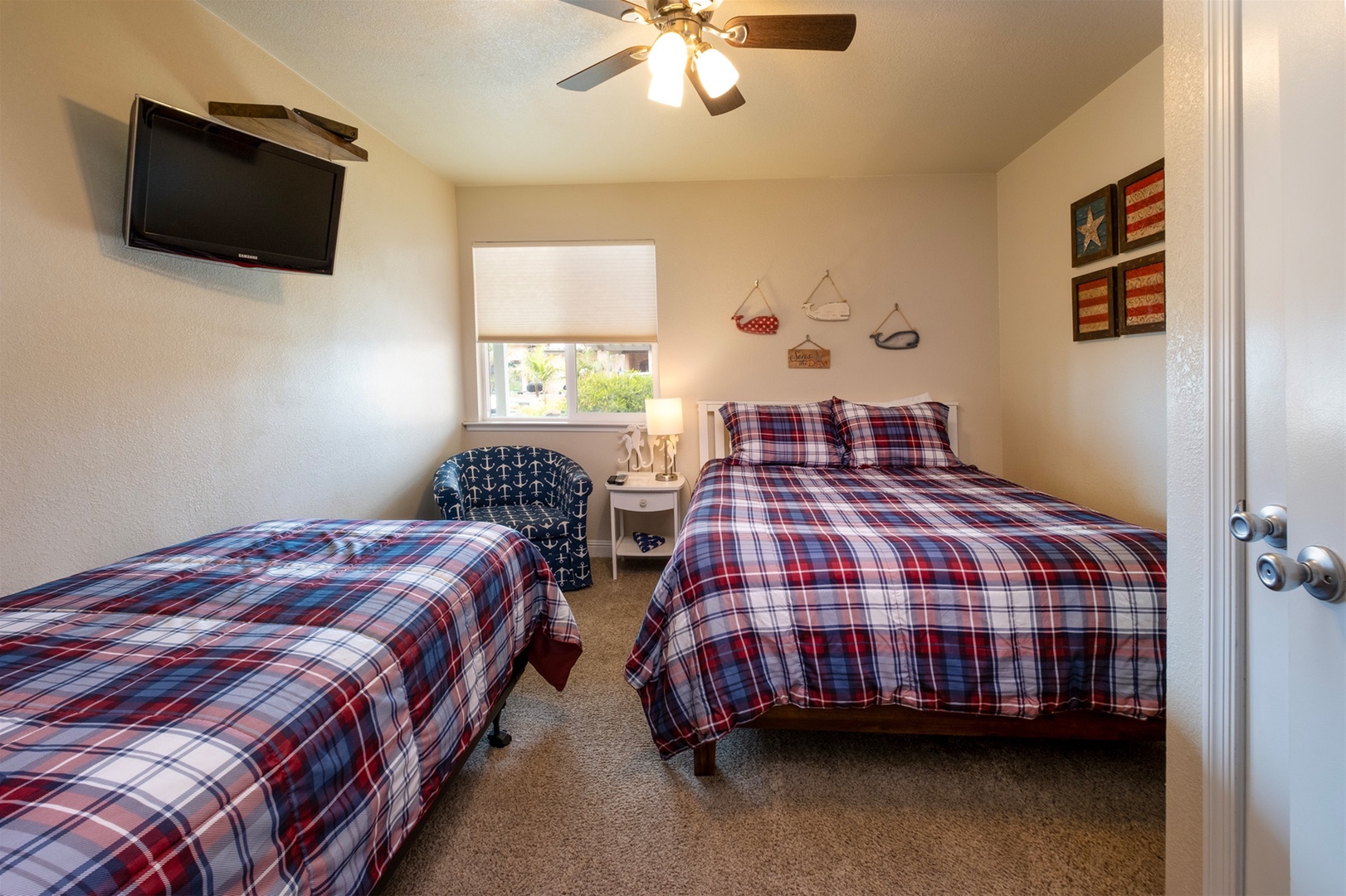 Second bedroom has a comfortable queen size bed, twin bed, and flat screen tv