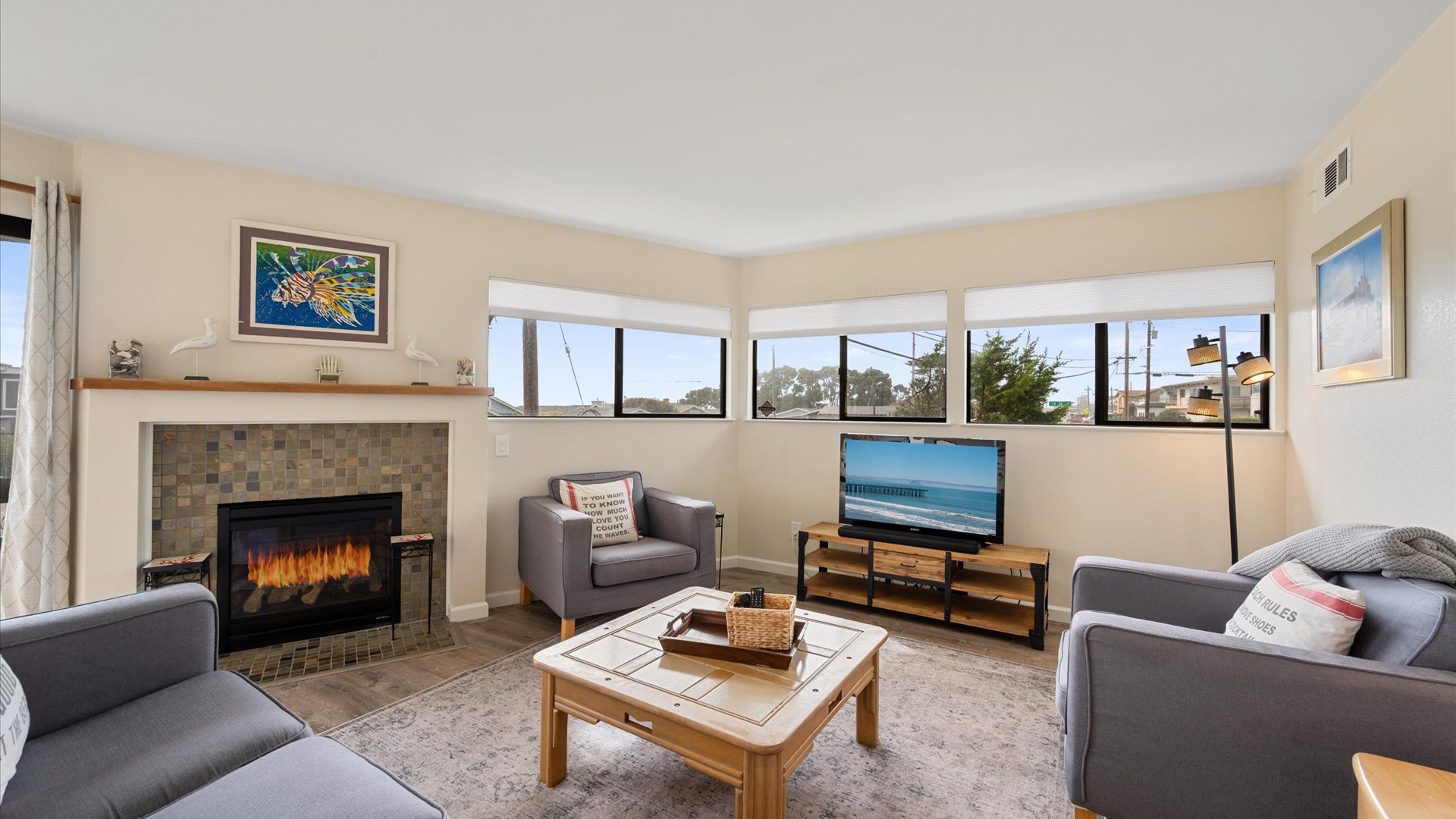 Unwind in your cozy living room where natural light fills the space through panoramic windows, perfect for relaxing by the fireplace after exploring.