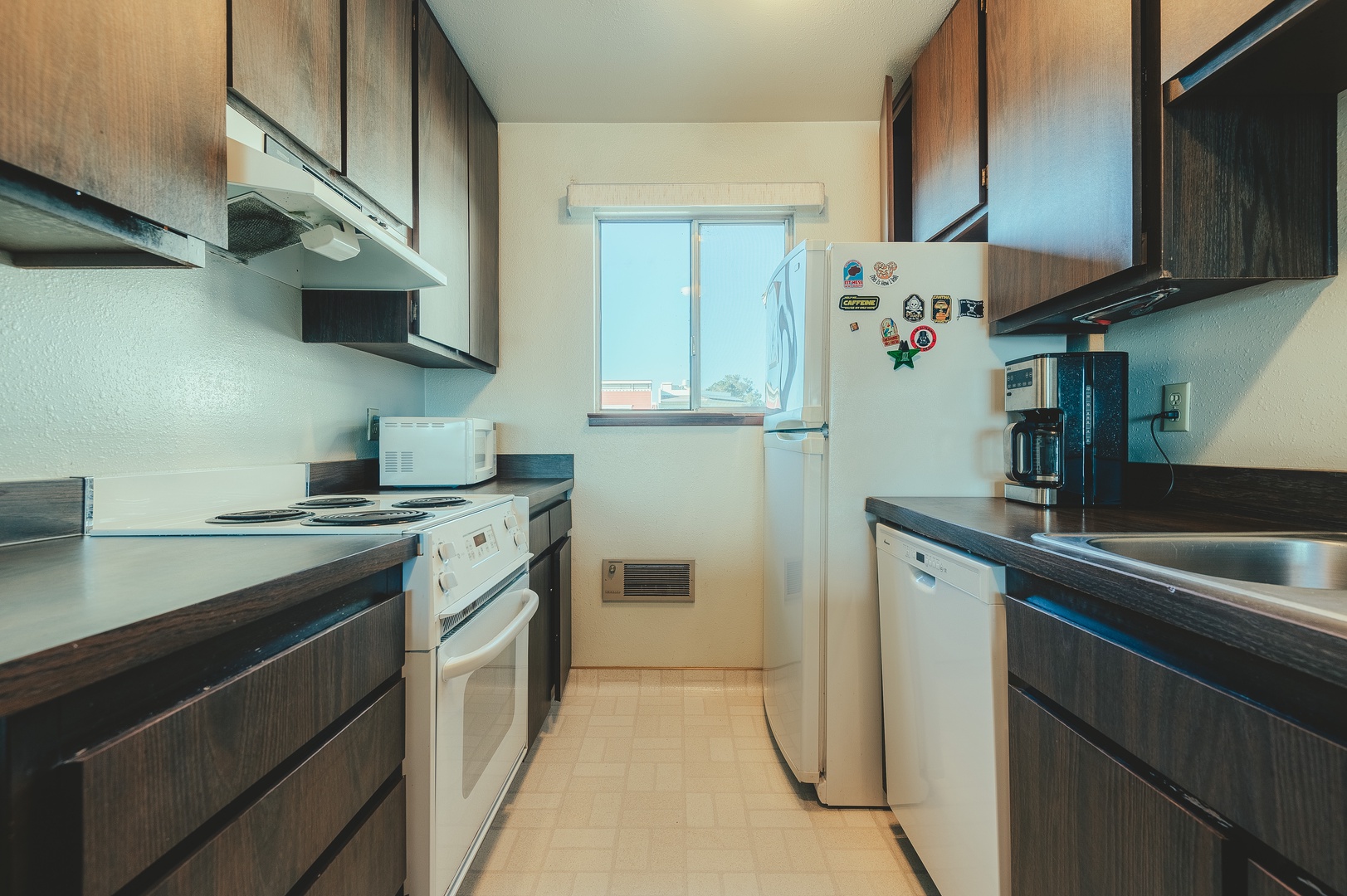Your fully equipped galley kitchen features ample counter space for preparing memorable meals during your stay.