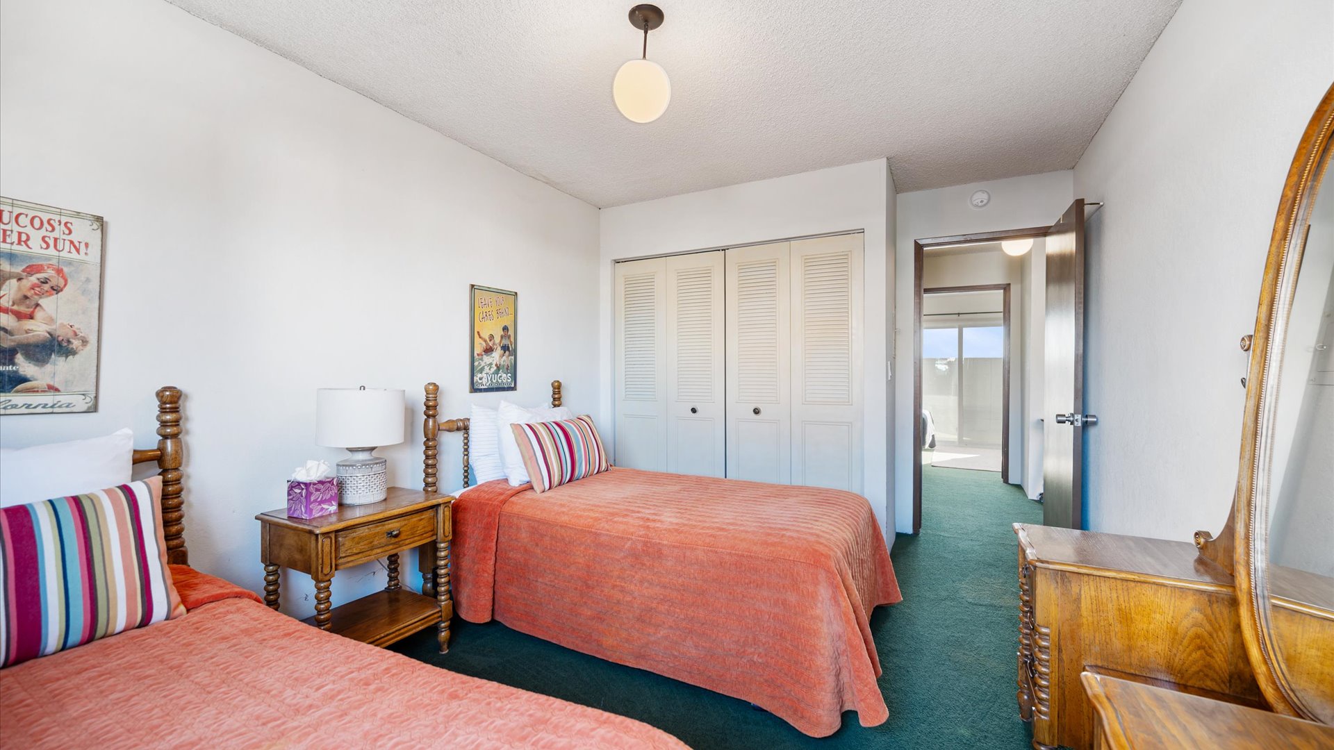 with cheerful orange bedding, vintage touches, and artwork, you'll love relaxing in this space