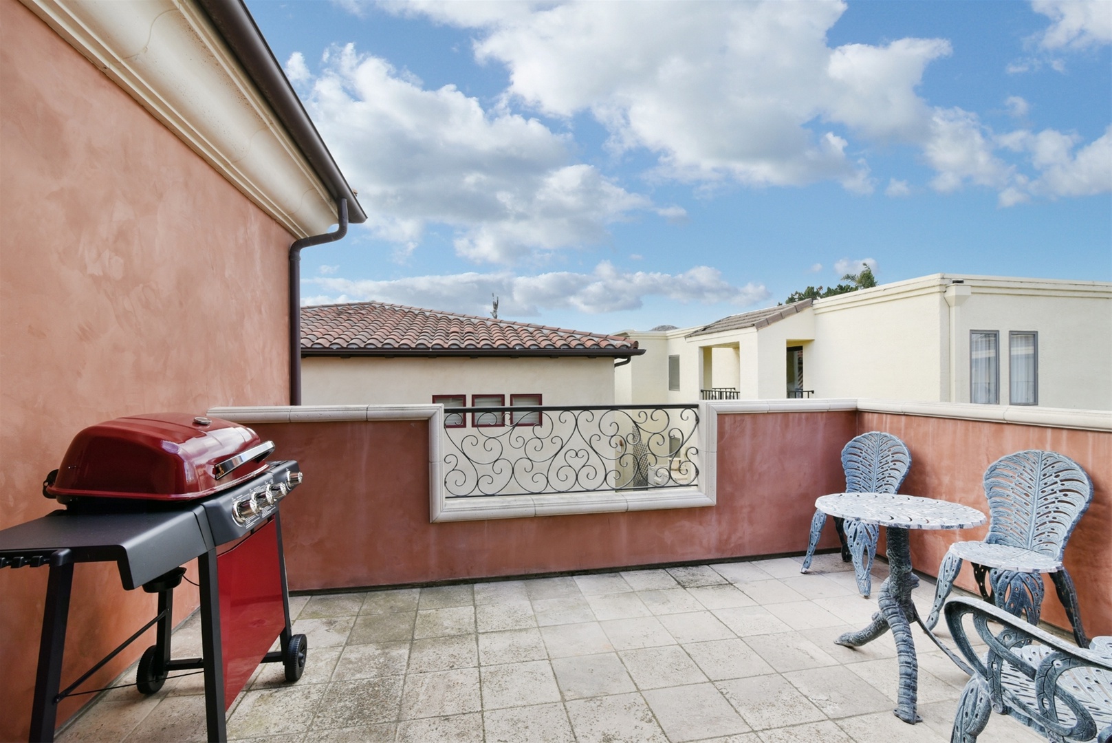 The balcony outside the dining area has a BBQ and seating area