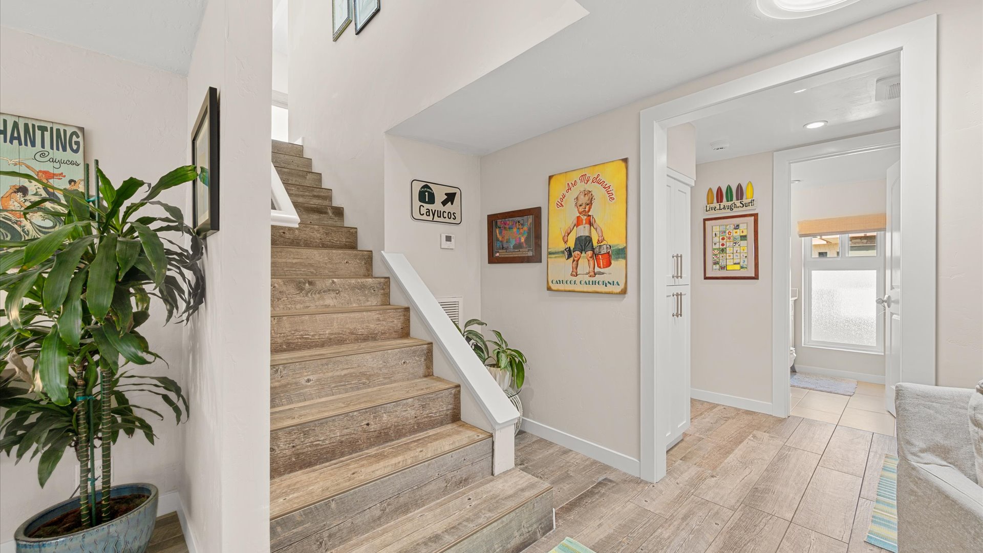 Beautiful hardwood floors, charming local art, and detailed finishes creates instant coastal vibes.