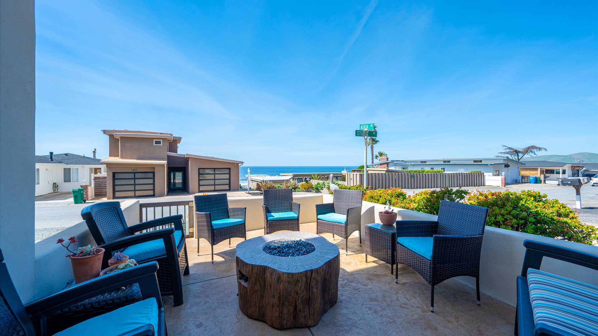 The front patio offers a fire pit and plenty of lounge seating