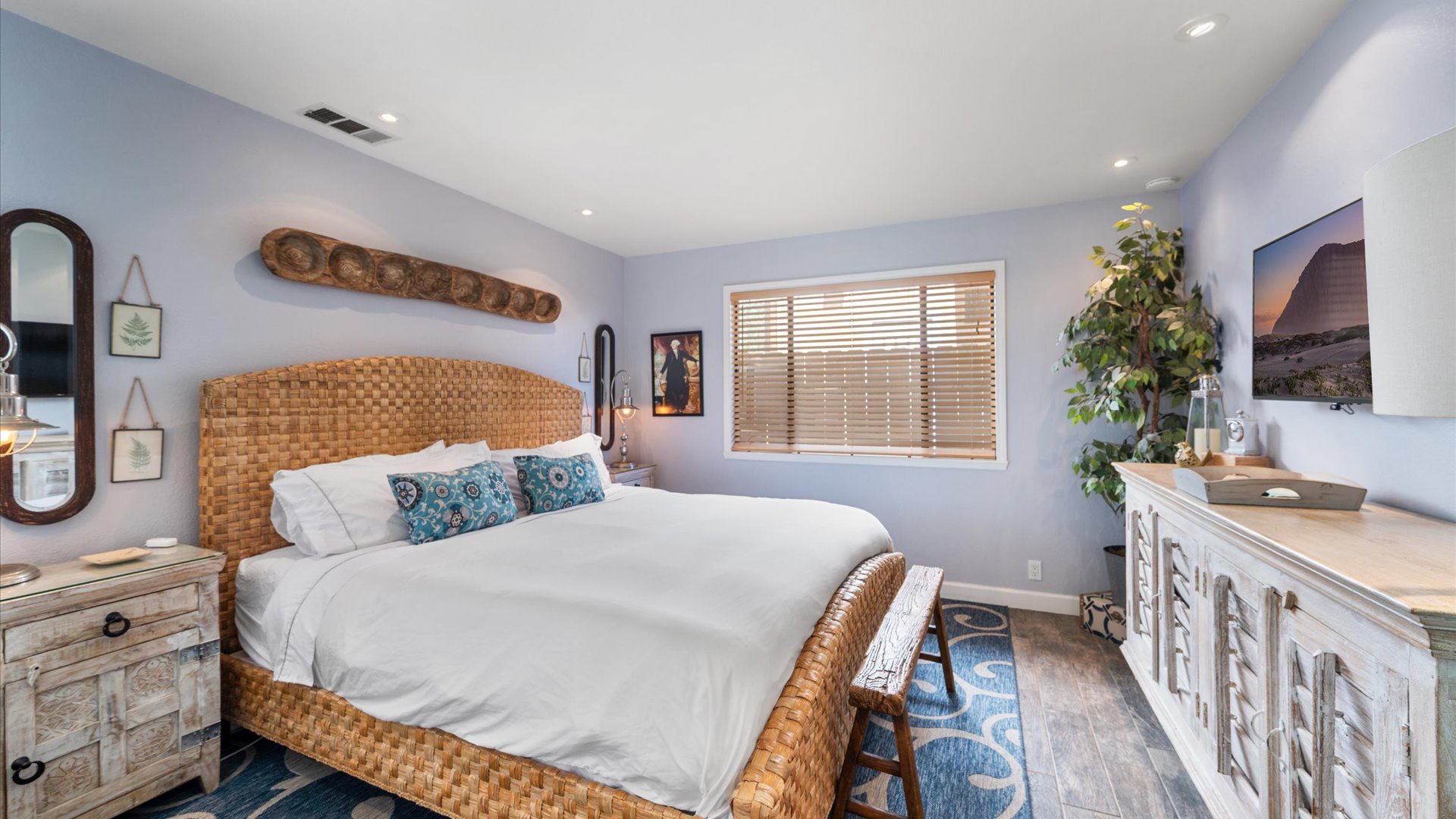Sink into your serene bedroom, where coastal blues and warm wicker create the perfect retreat for restful nights.