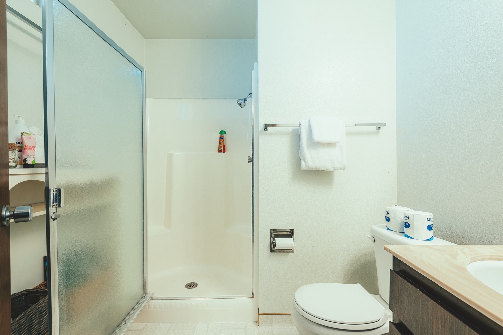 Second bathroom features a step in shower