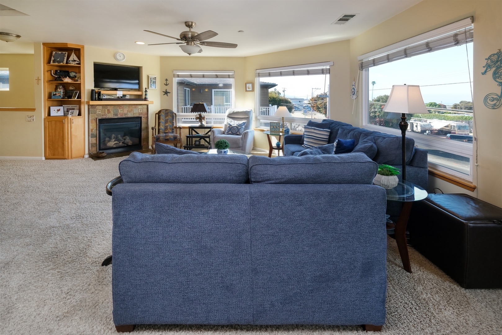 The living space includes a large flat screen tv, DVD player, and fireplace.