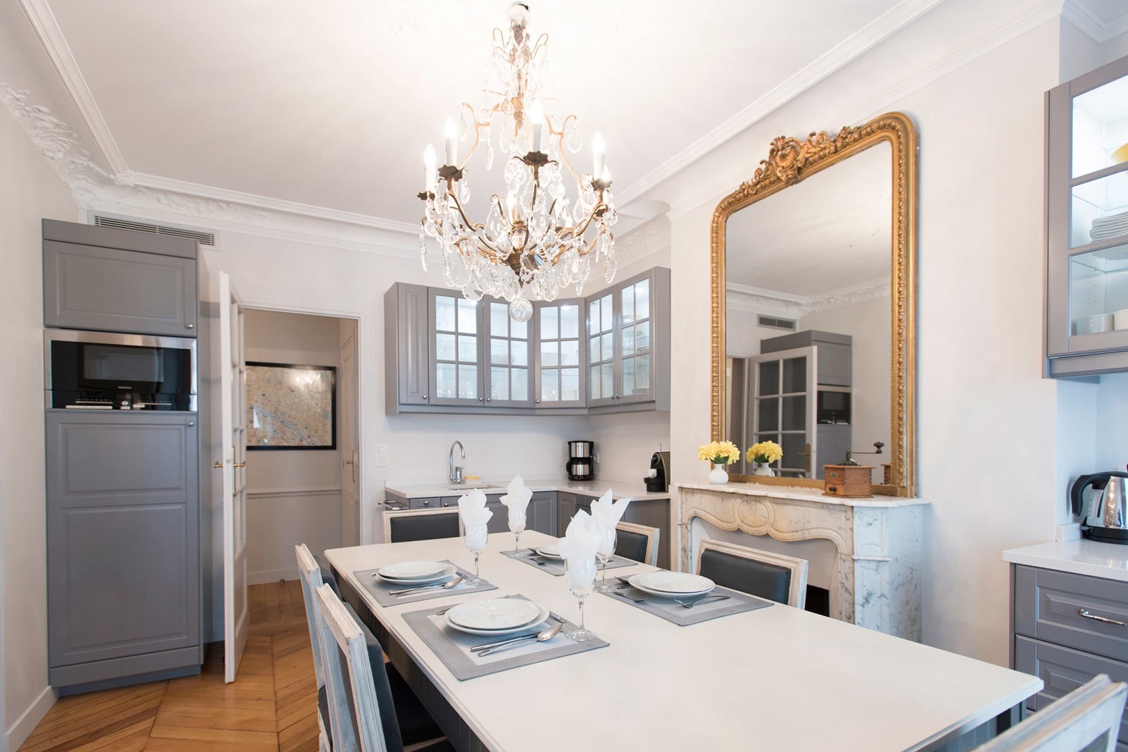 The marble fireplace and antique mirror add an elegant touch.