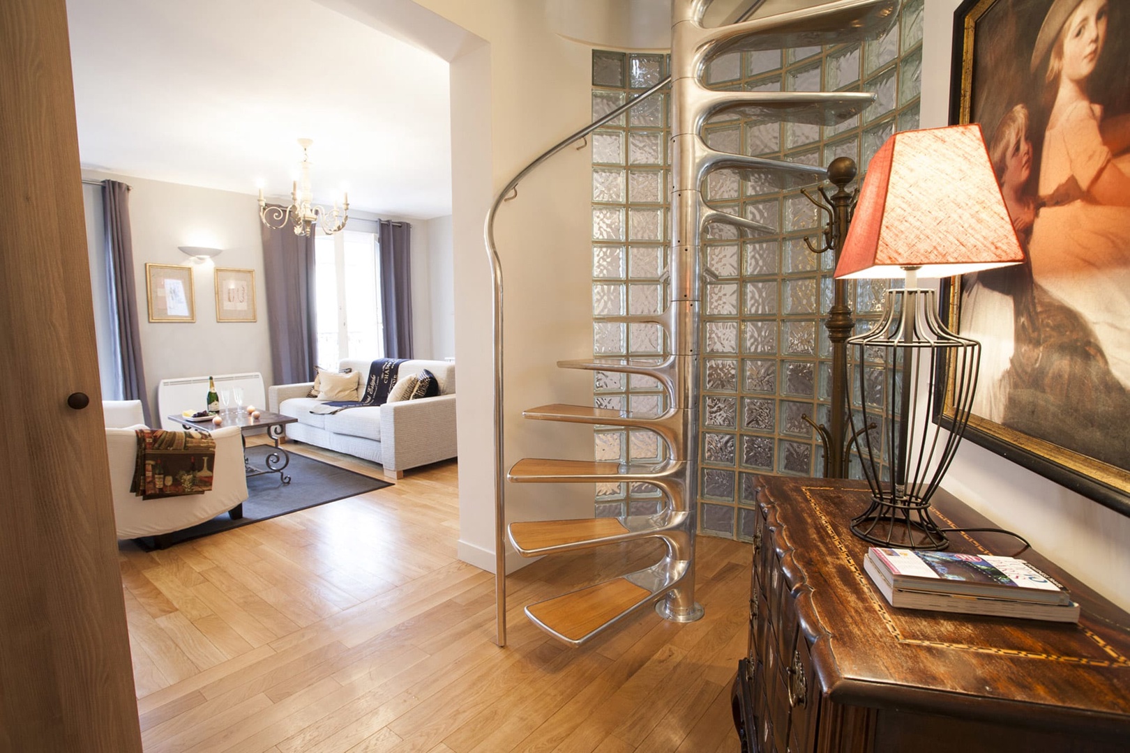 The spiral staircase adds even more flair to the beautiful apartment!