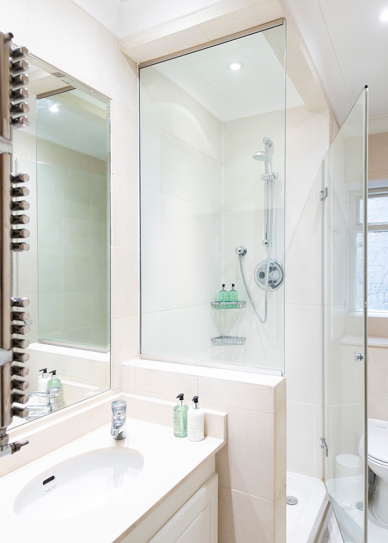 Second full bathroom with a glass enclosed shower.