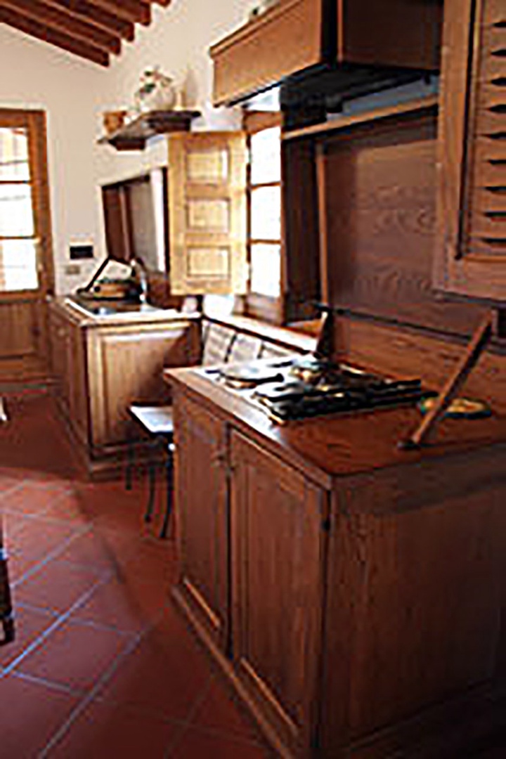 The warm oak of Tuscan style cabinetry in Loggetta's kitchen.