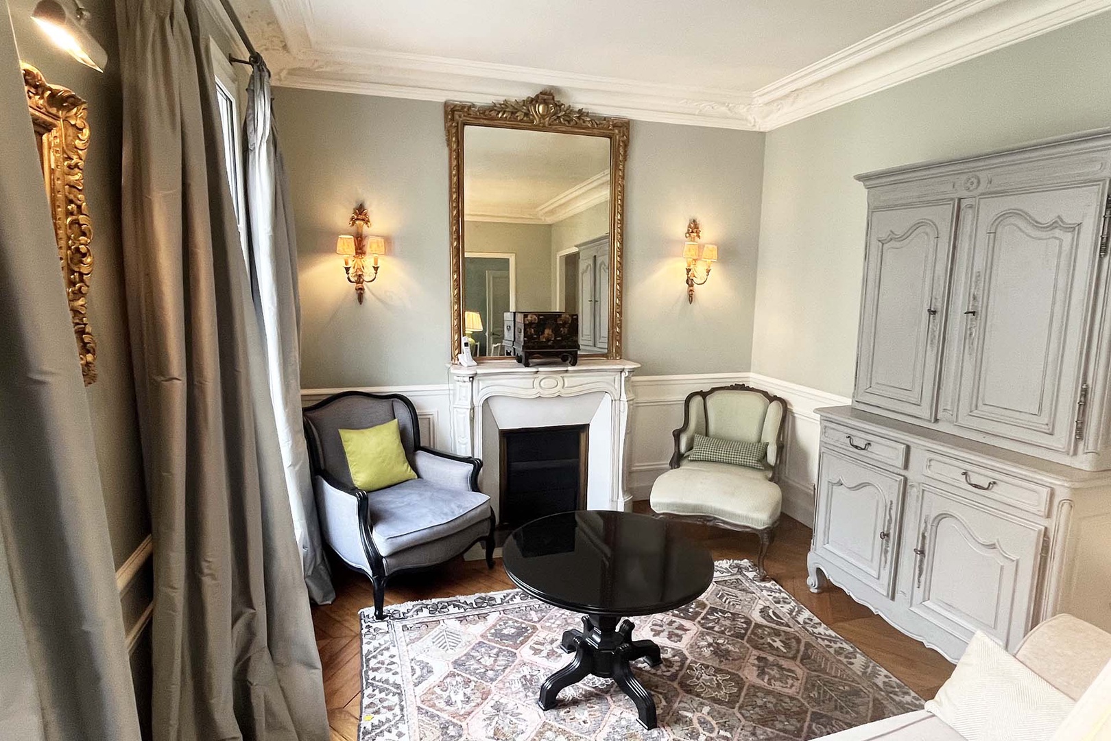The beautiful fireplace and mirror are focal points in the living room.