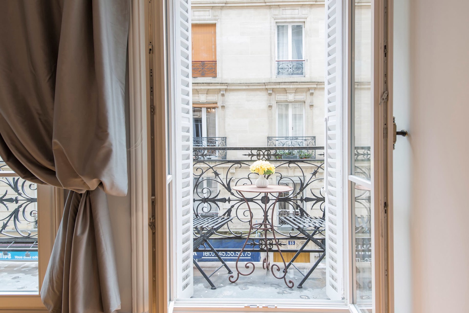 Double French doors lead out to the apartment's balcony.