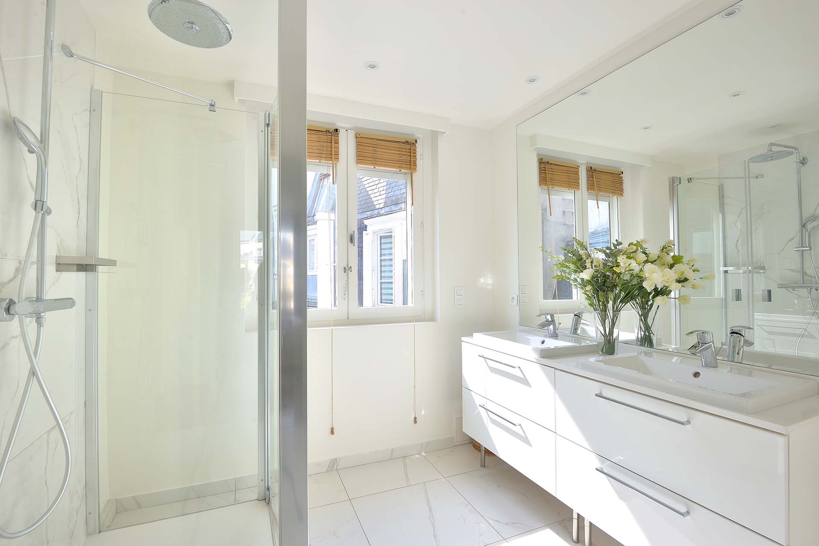 Spacious bathroom 1 with shower and double sink.