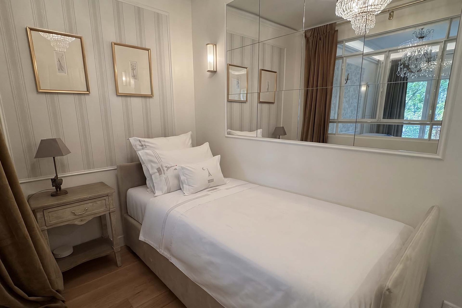 Mirrored walll panels in bedroom 2 expand the space visually.