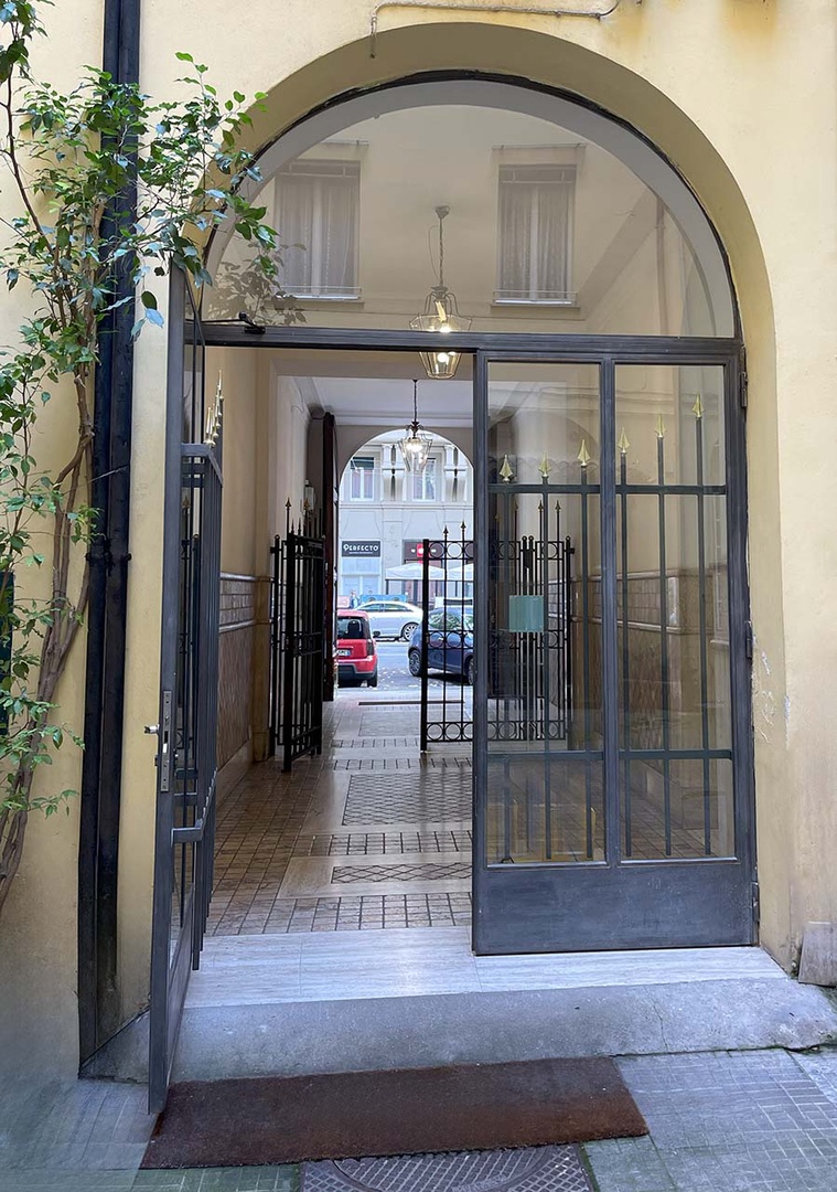 Enter through a locked and gated passageway to the courtyard to find the entrance of Castagna.