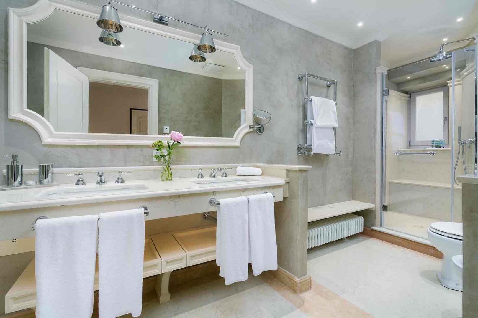 Soak in elegance with a generous vanity, rainfall shower, and  bathtub.