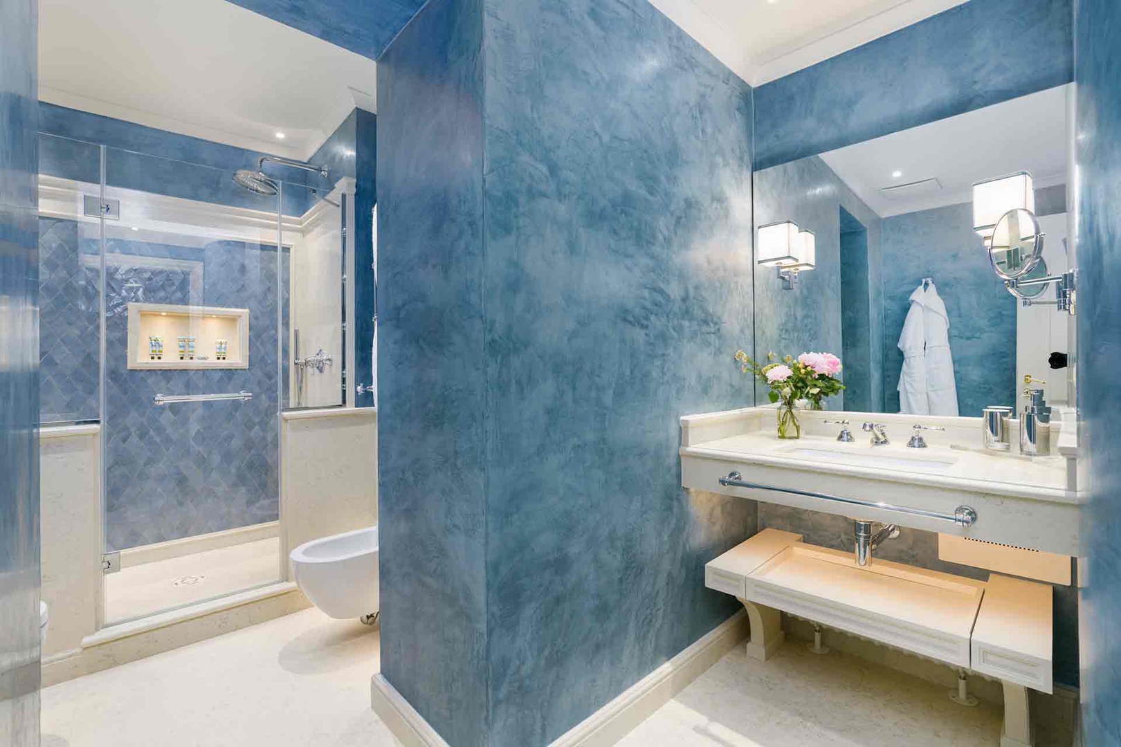 Step into the spa-like en suite bathroom 2, with dramatic blue walls creating a calming oasis.