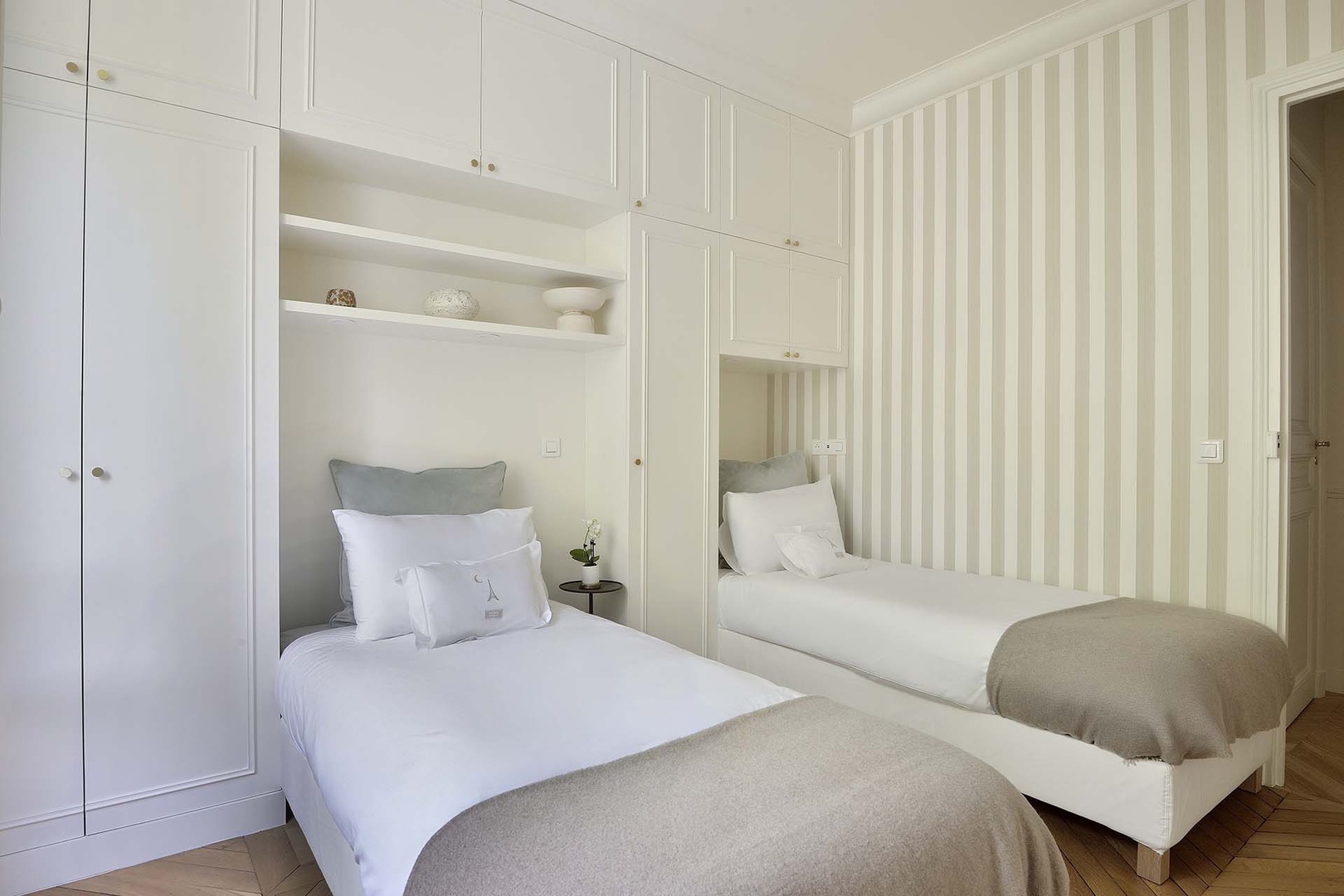 Bedroom 2 with single beds and plenty of storage.