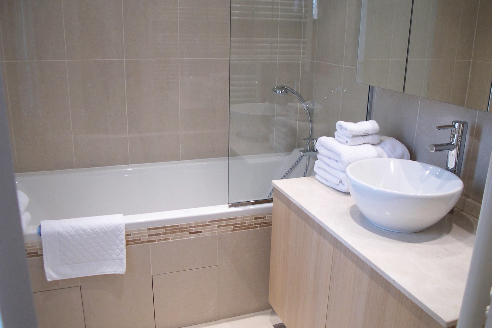The en suite bathroom offers a tub for relaxing as well as a shower.