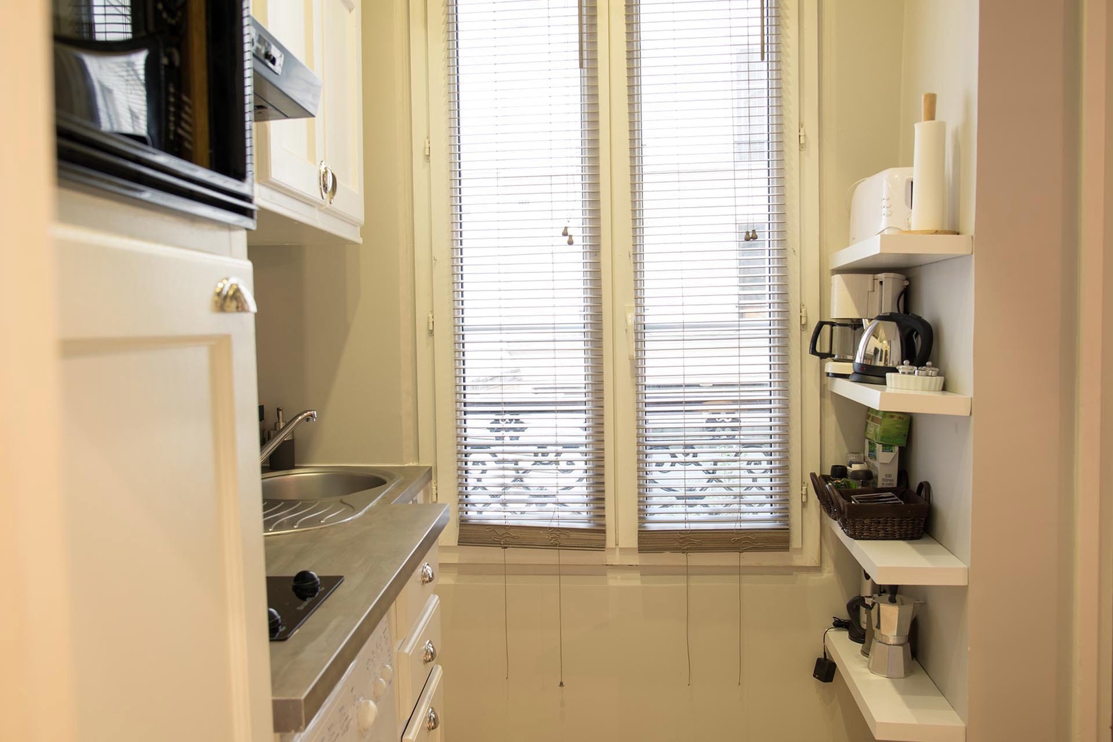 A lofty window adds extra natural light to the kitchenette.