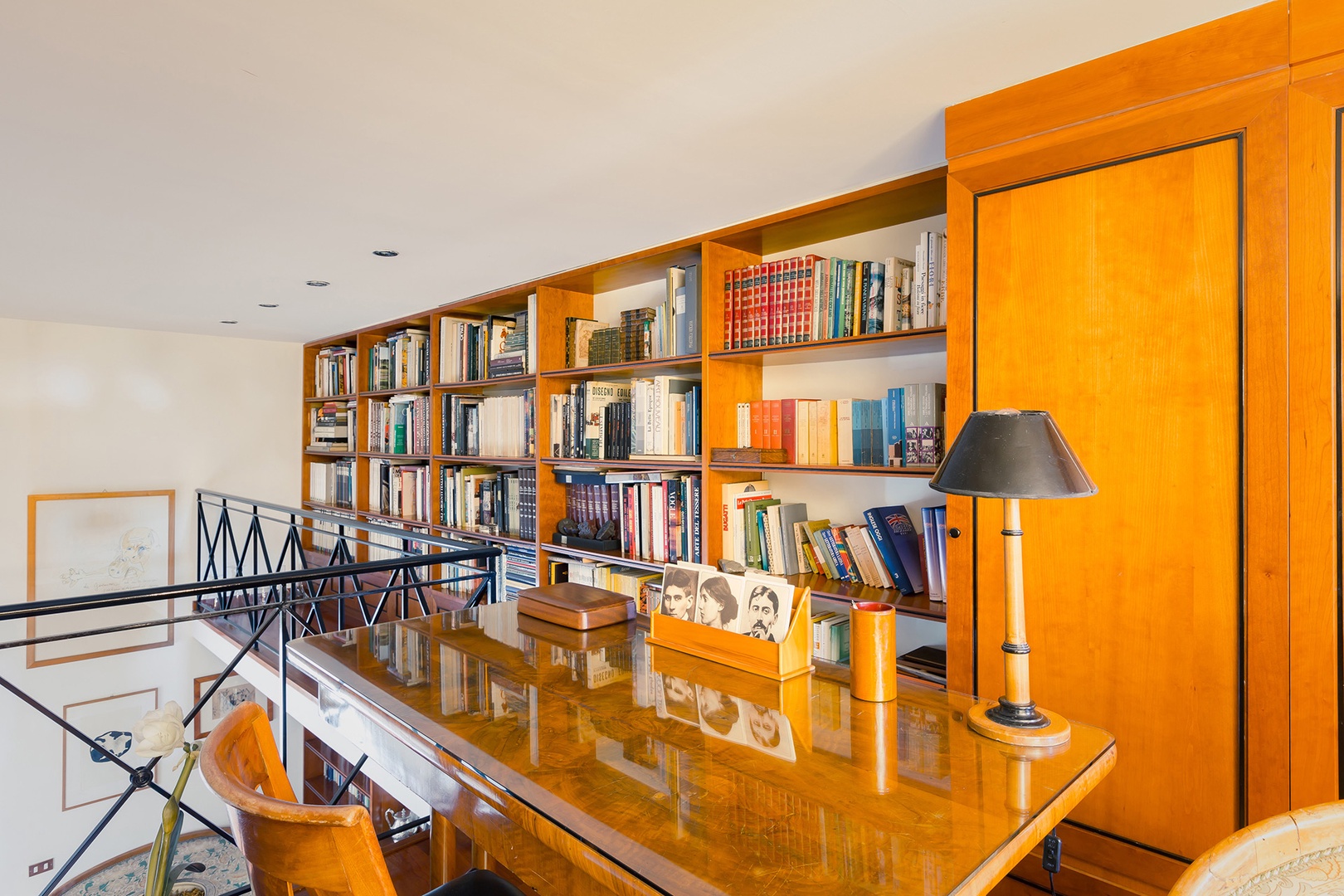 The mezzanine with library and desk above the dining room.
