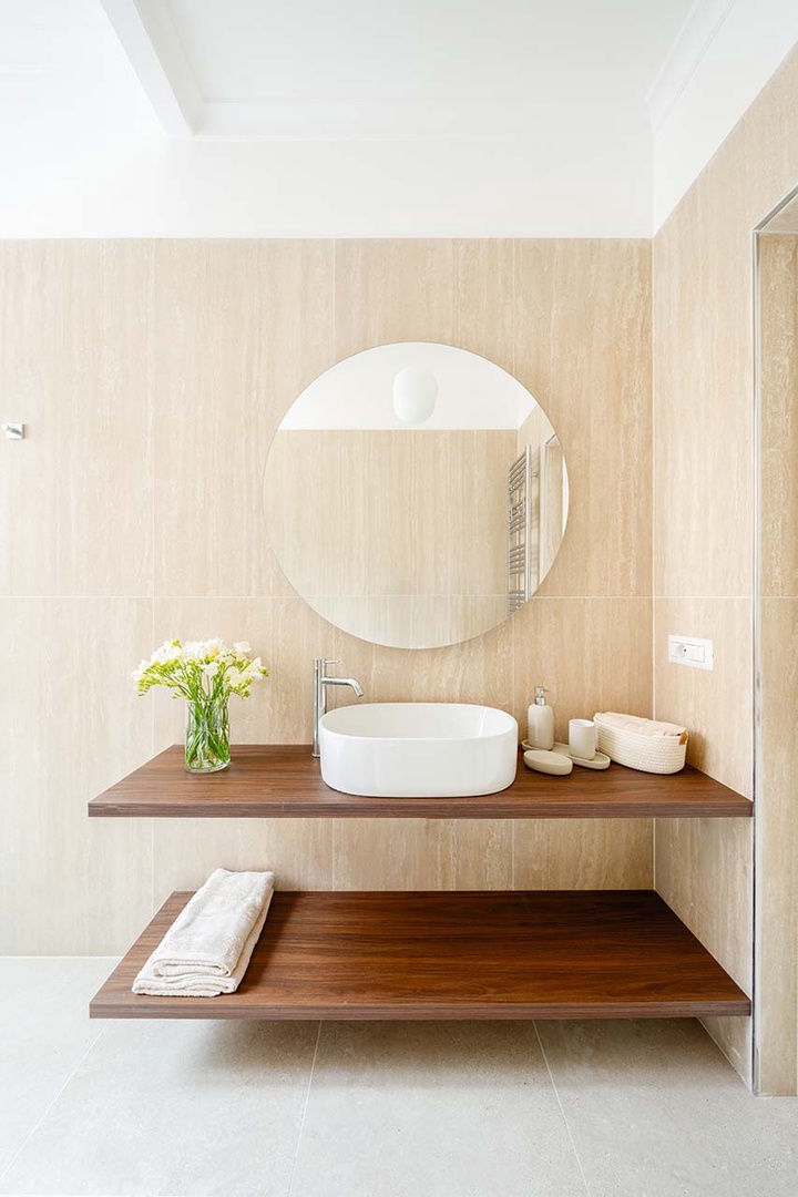 Modern sink and open storage.