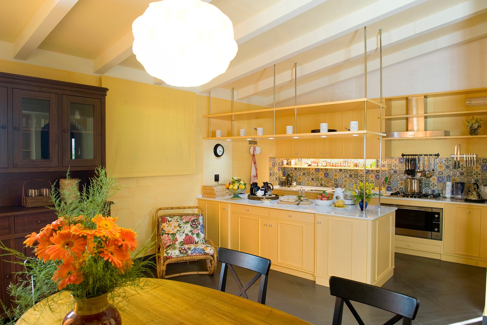 Kitchen is bright, well organized and well stocked with pots, pans, dishes.