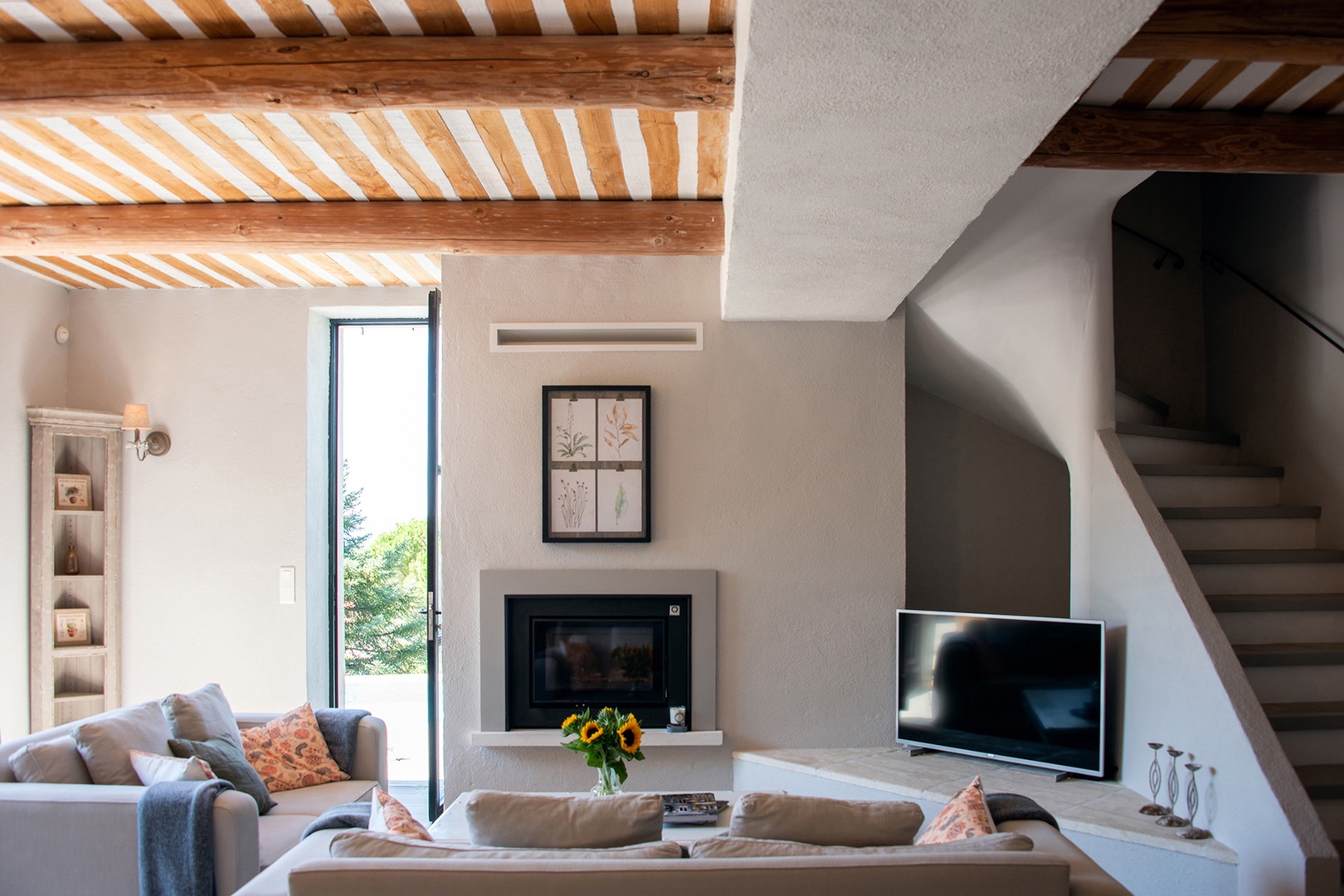 Comfortable contemporary living room opens to terrace with pool.