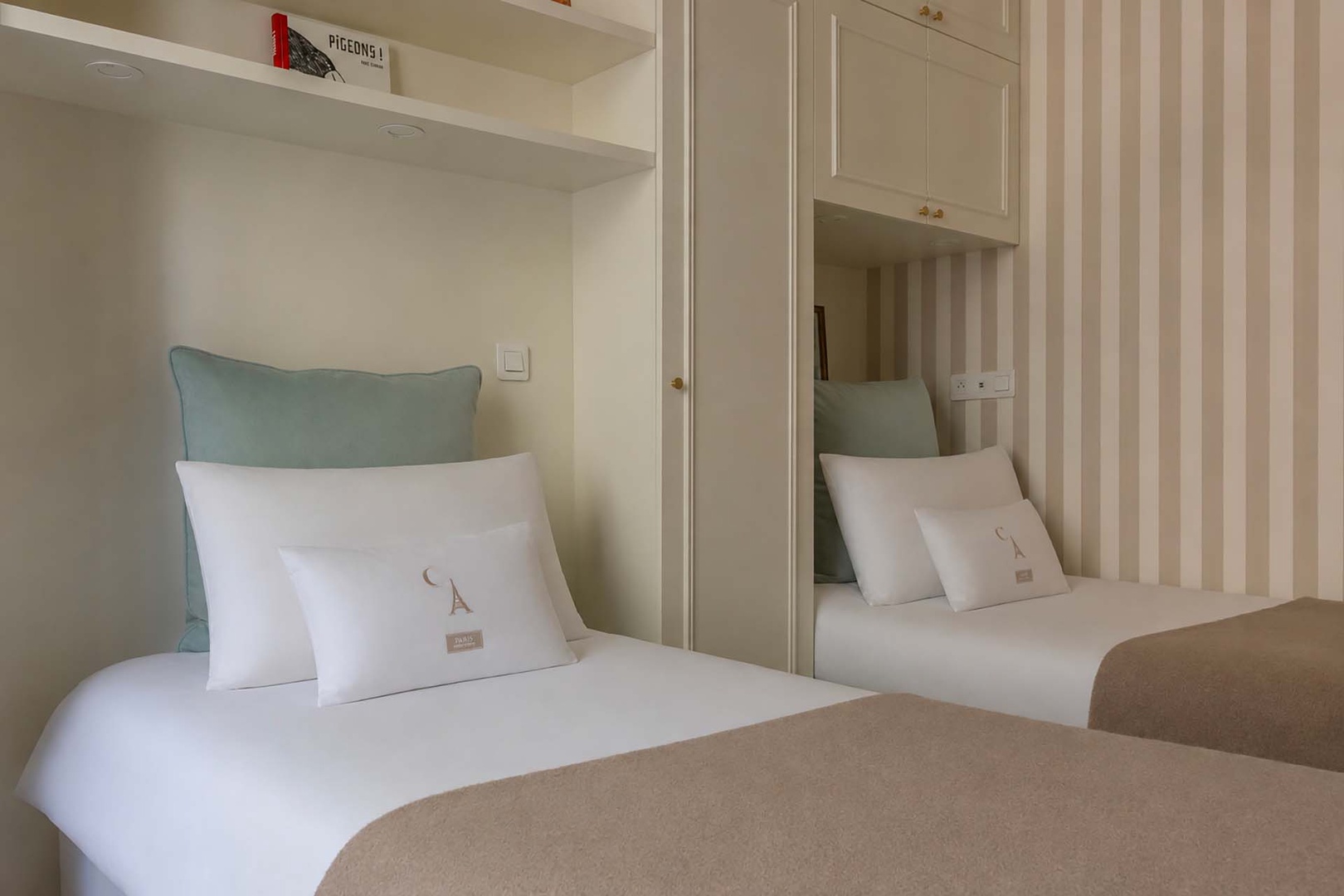 Bedroom 2 with single beds and plenty of storage.