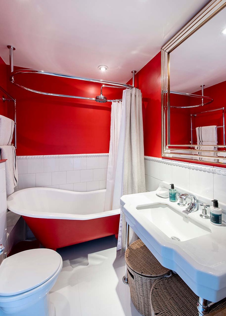 En suite bathroom to bedroom 2 with clawfoot cast iron bathtub.