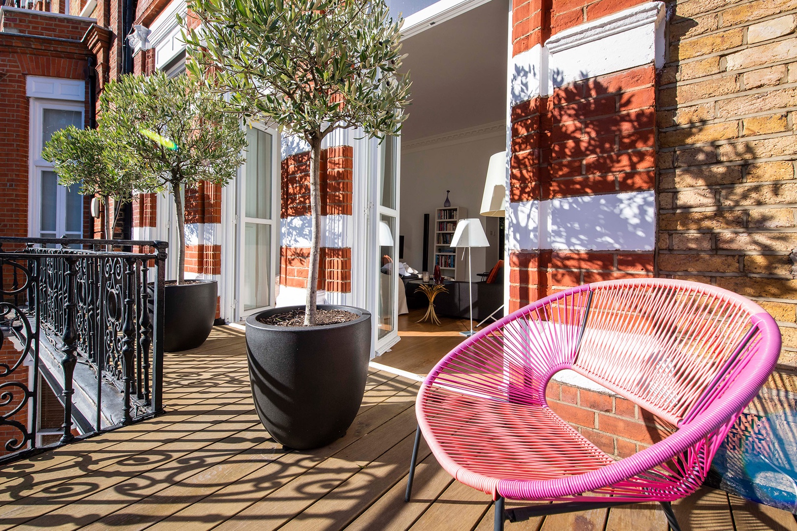 Sit outside on the balcony overlooking a historic Kensington street.