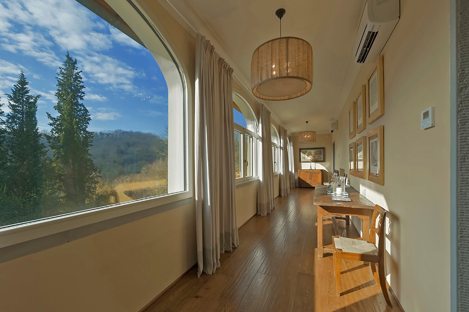 Enclosed loggia runs along the entire front of the house with beautiful views.