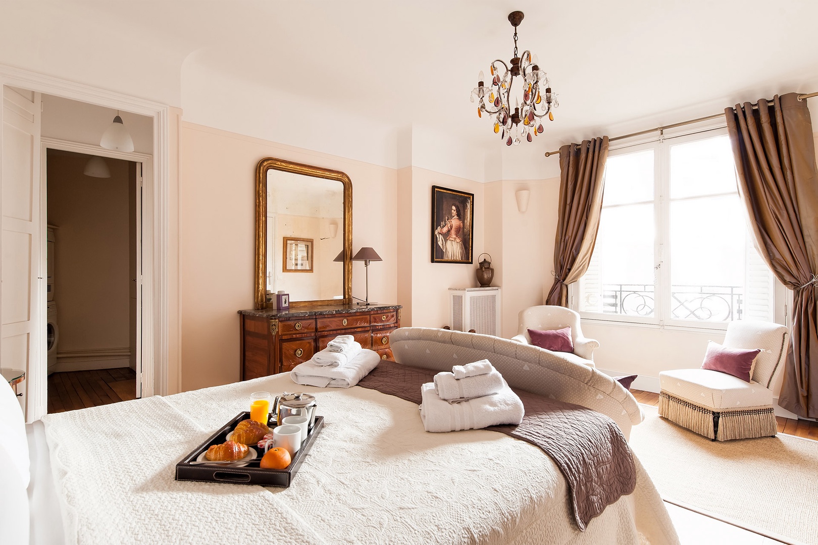 Sunlight streams through the large bedroom window.