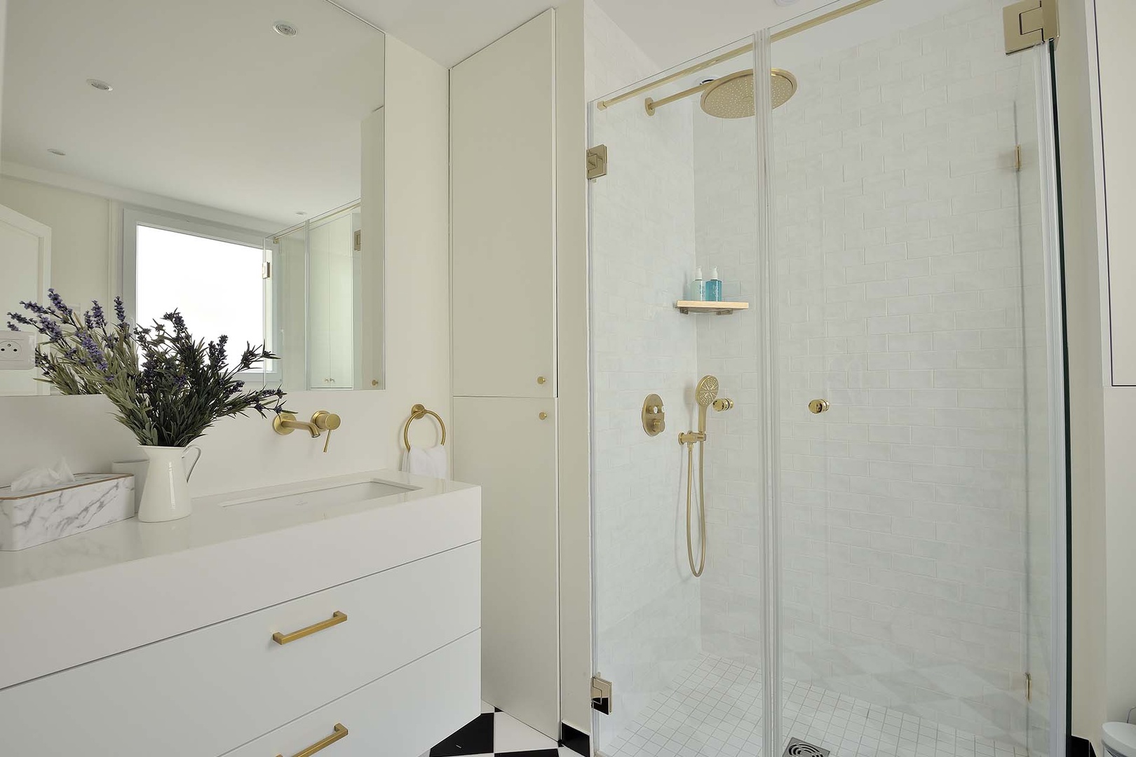 Spacious bathroom 1 has a shower, toilet and sink.