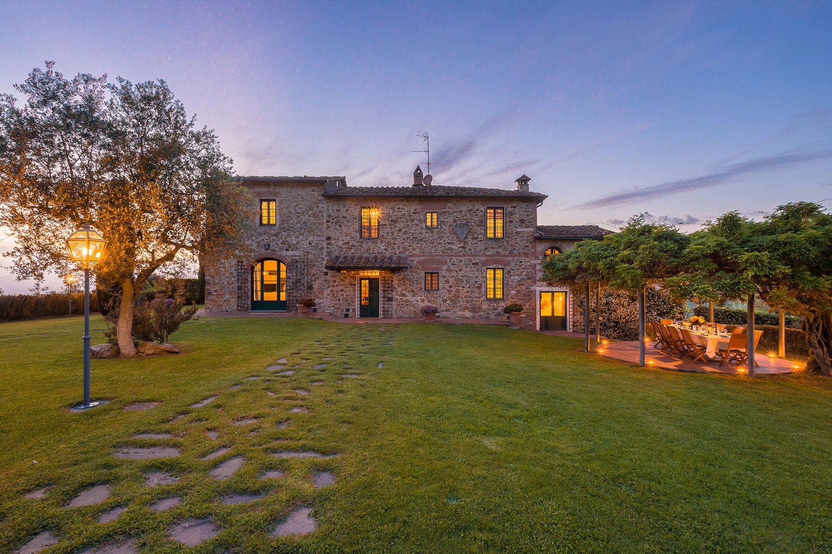 The lighting around the pool & gazebo to the right of this photo invites you to leisurely evenings.