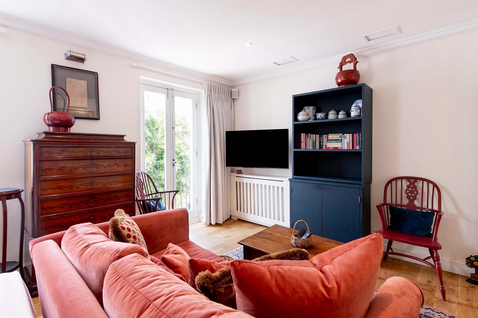 Doors open to a charming step out balcony overlooking the mews.