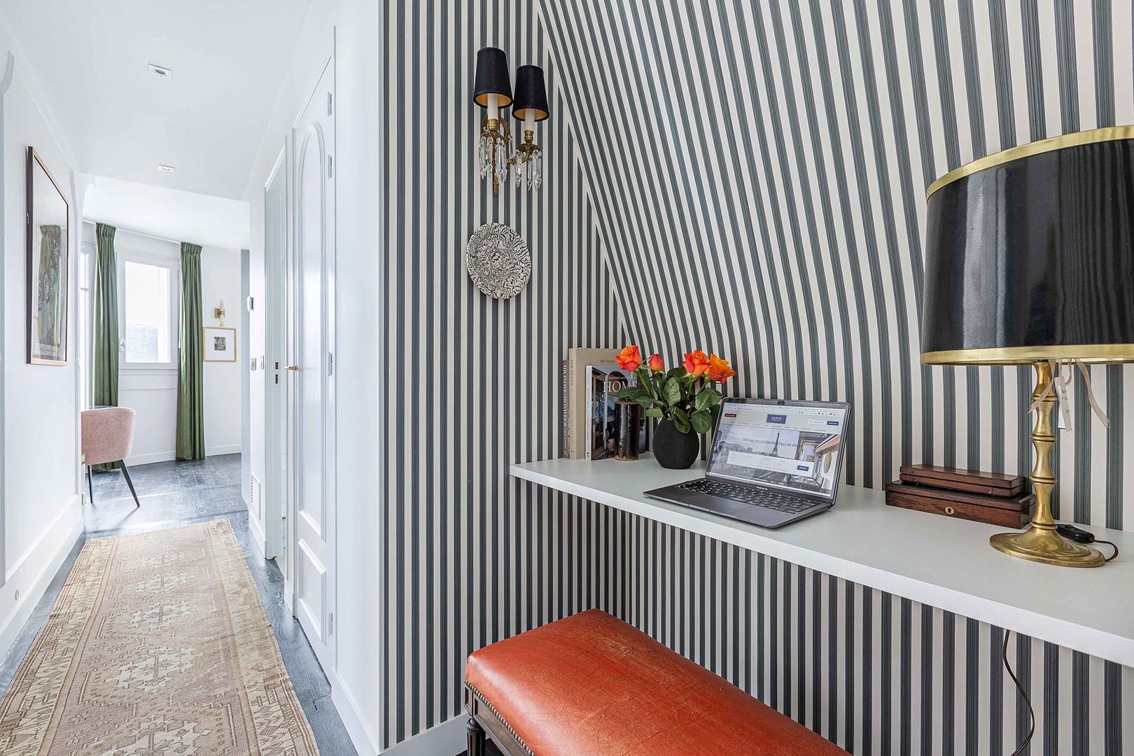 Built-in desk by the entrance is practical for working remotely.