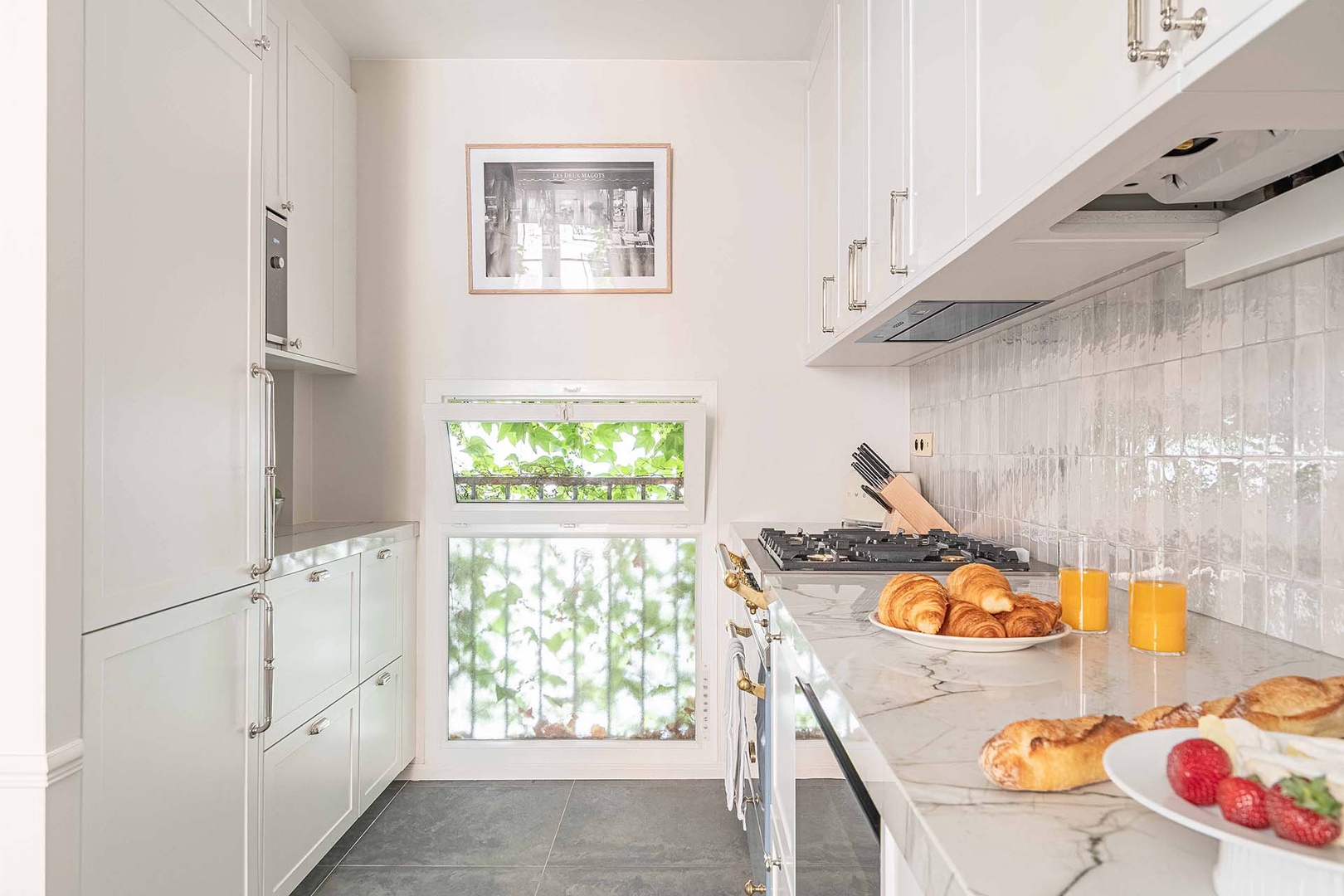 Kitchen is full of light and beautifully designed.