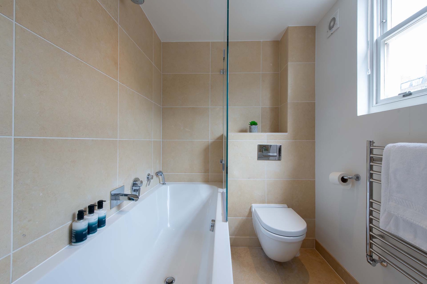 Bathtub and shower combo in bathroom 3.