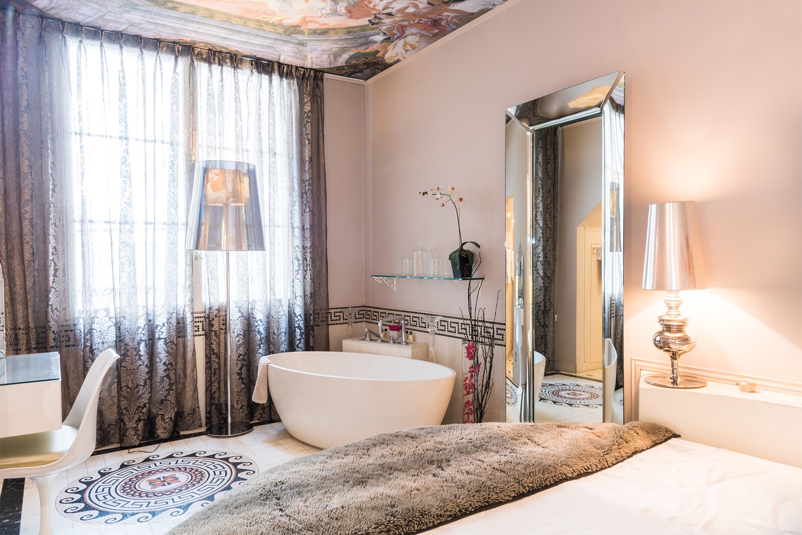 The bedroom is an oasis with a large soaking bathtub.