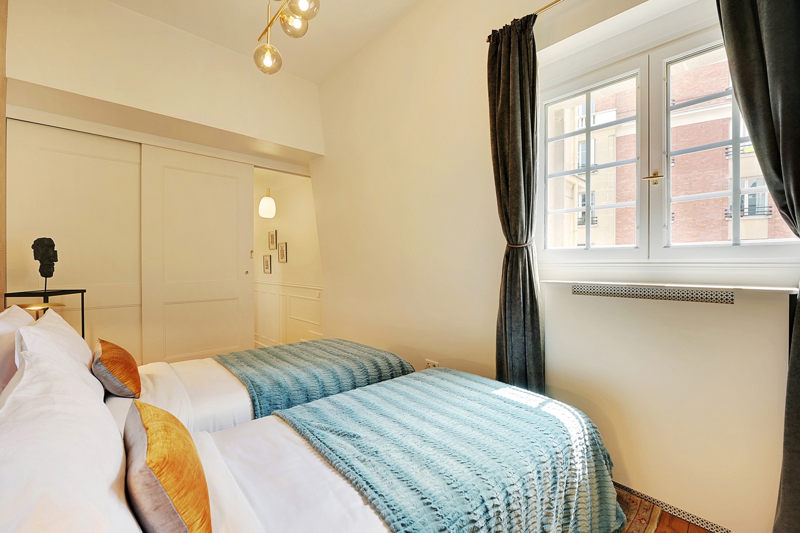 Bedroom 3 has two single beds that together form a dual extra-wide queen bed.