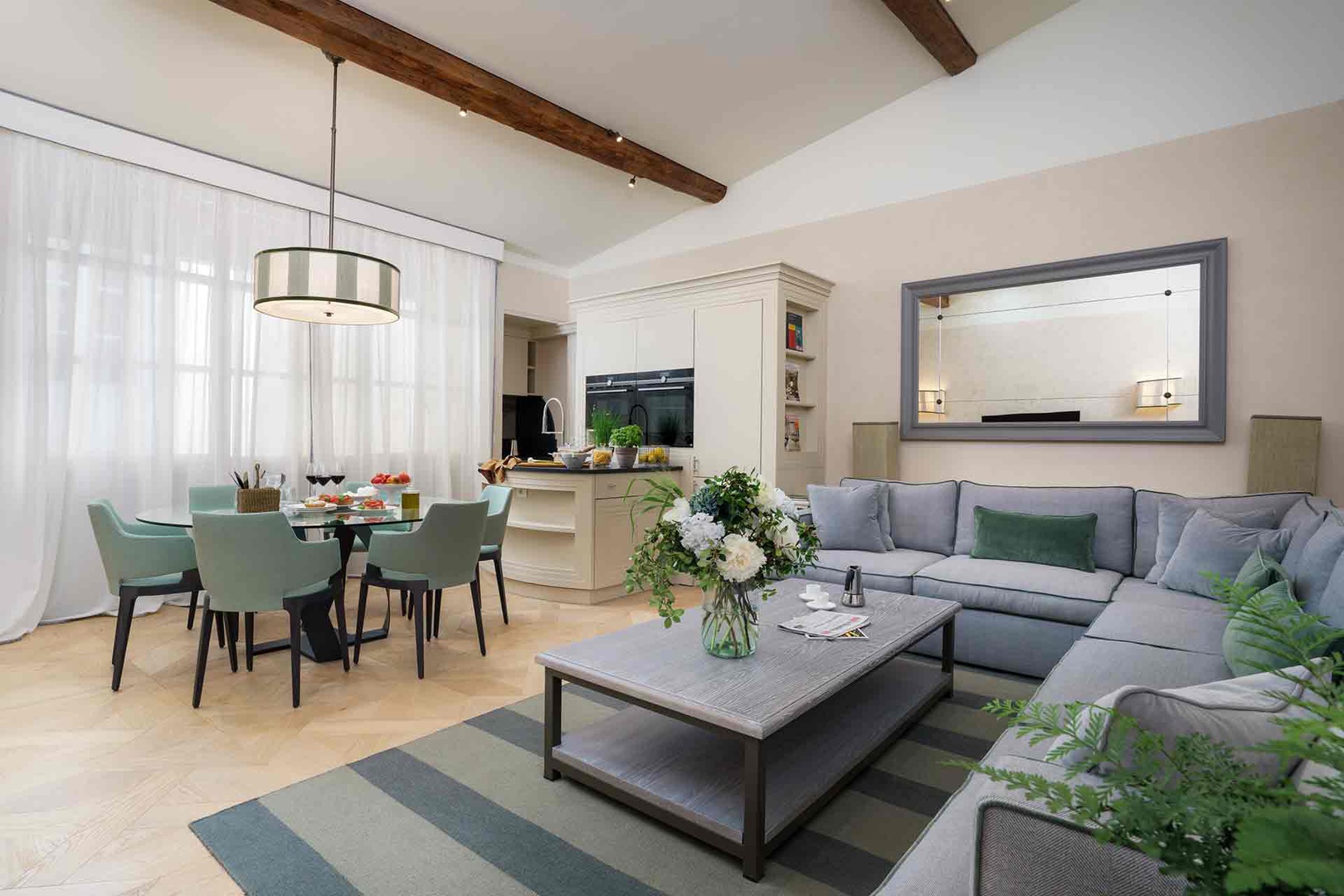 Step into the open-plan living space with exposed wooden beams adding rustic charm overhead.