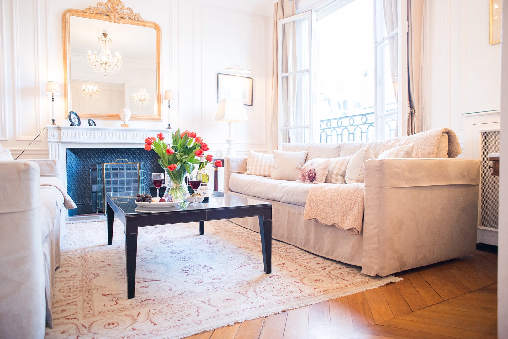 Sunlight streams into the living room through lofty French windows.