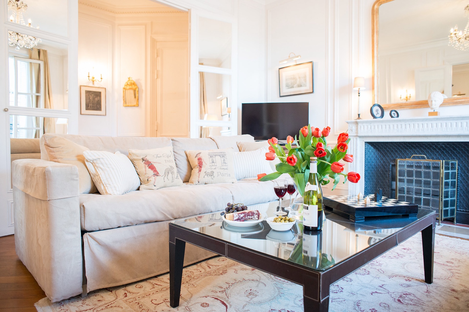 Mirrored French doors separate the living area from the hall.