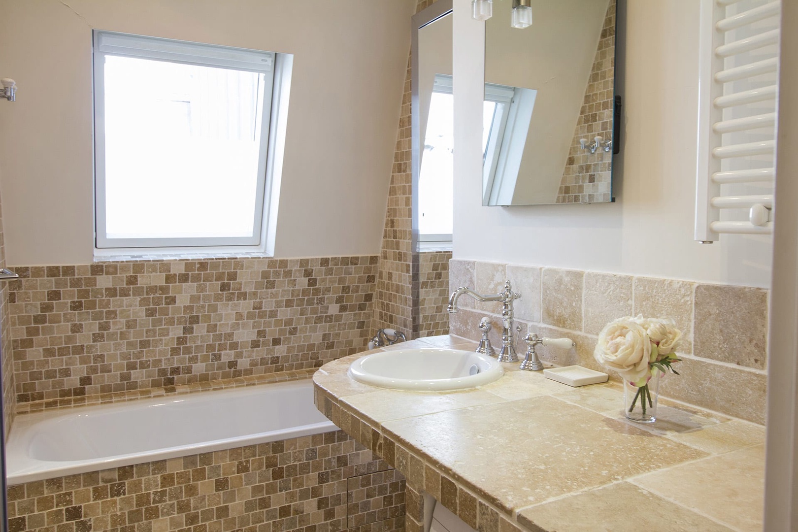 The stylish bathroom comes with a bathtub and separate shower.
