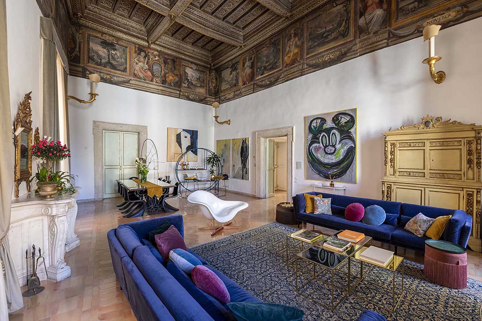 An intriguing contrast of ancient ceiling and frescoes with modern furnishings.